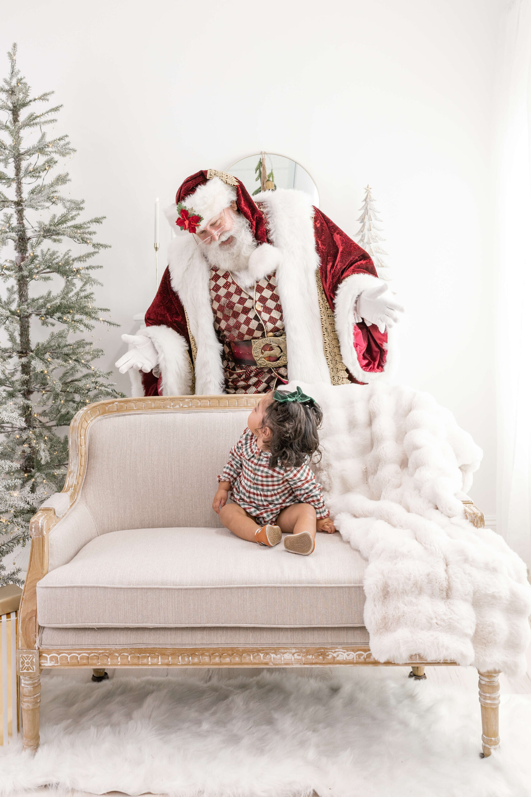 Little girl on a couch looking back at Santa