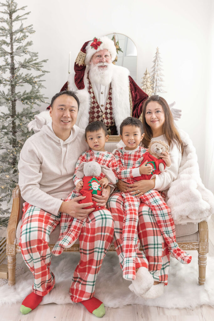 Family in matching pajamas with Santa in Old Town Tustin