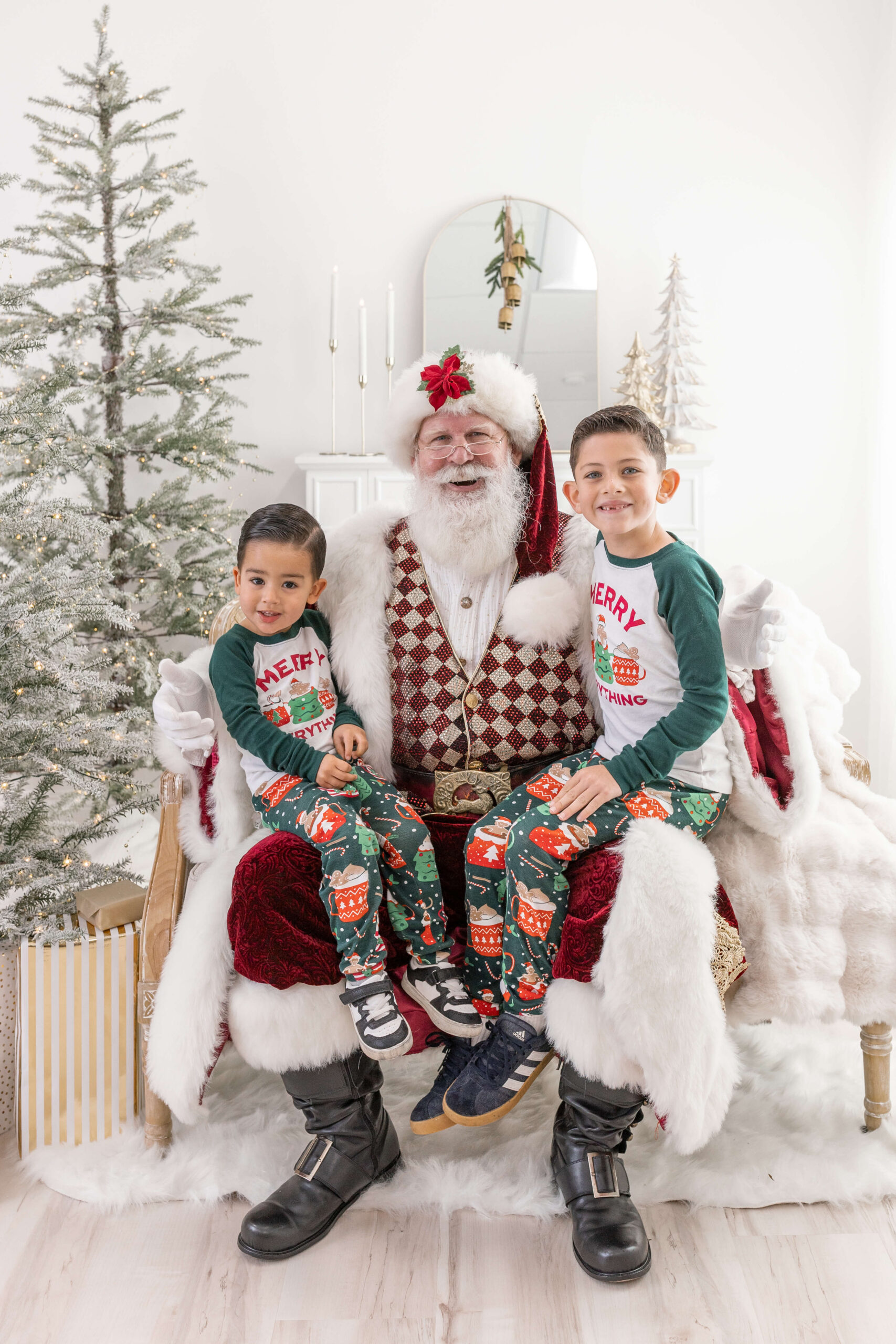 2 boys sitting on Santa's lap