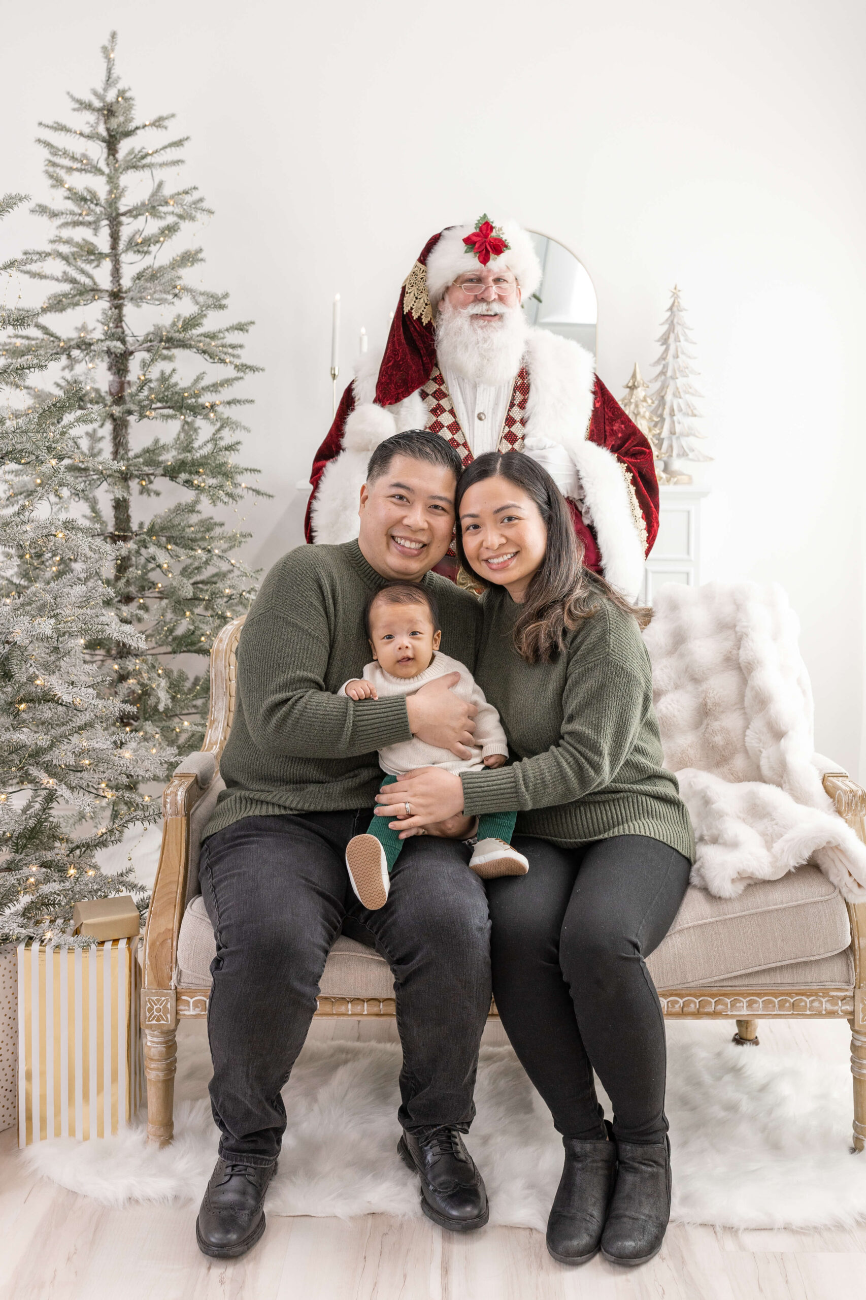 Santa standing behind a family on a couch
